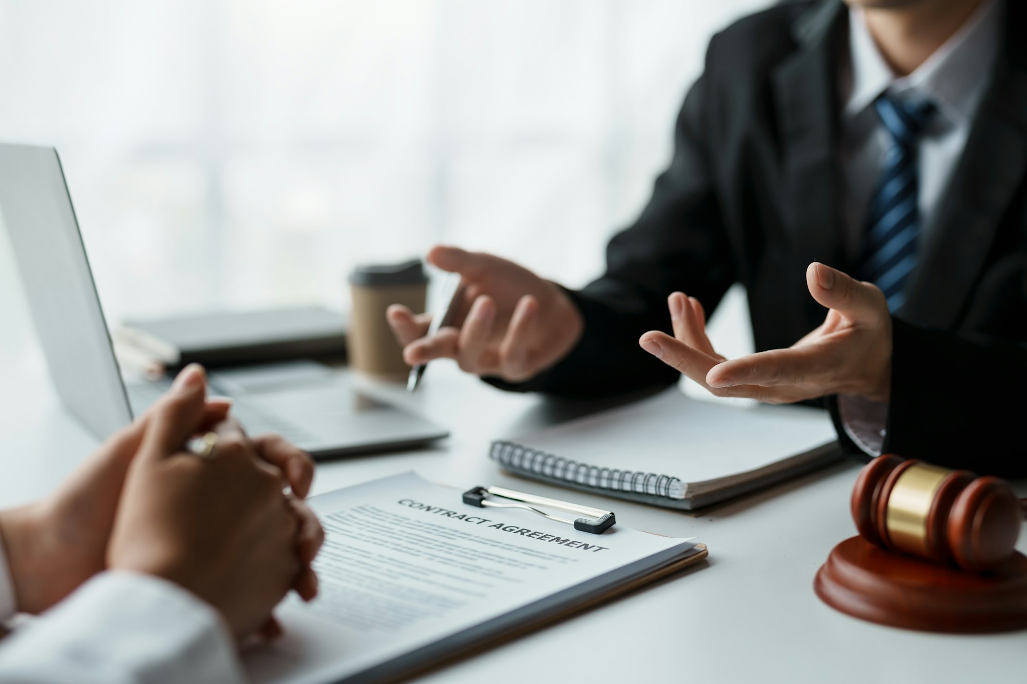 Businessman and lawyer discuss and advice on contract documents.